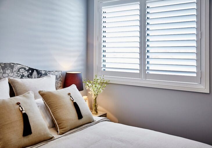 White shutter blinds for bedroom window with modern decor